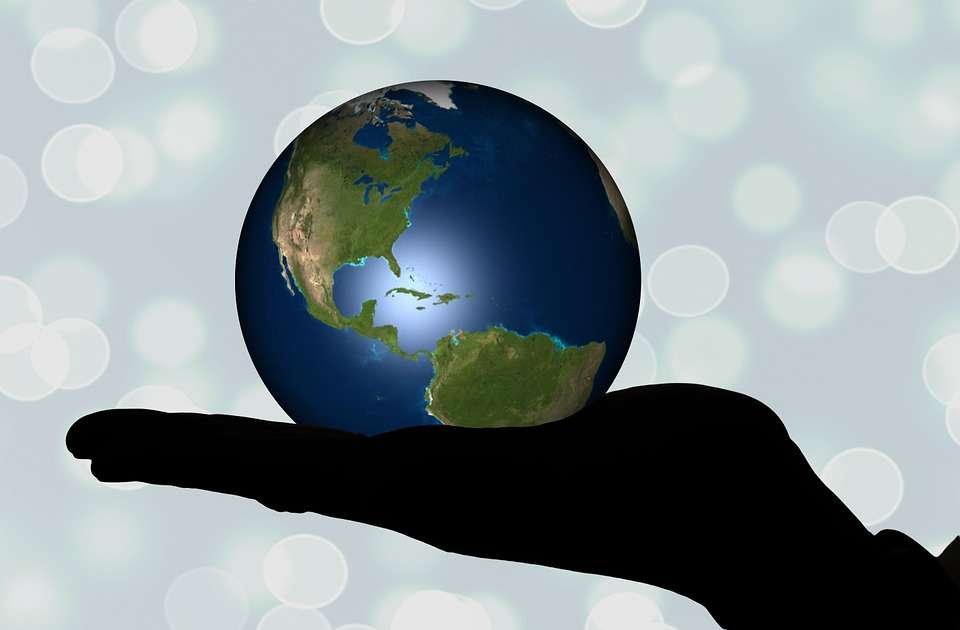 World of Faith - Hand holding a globe.